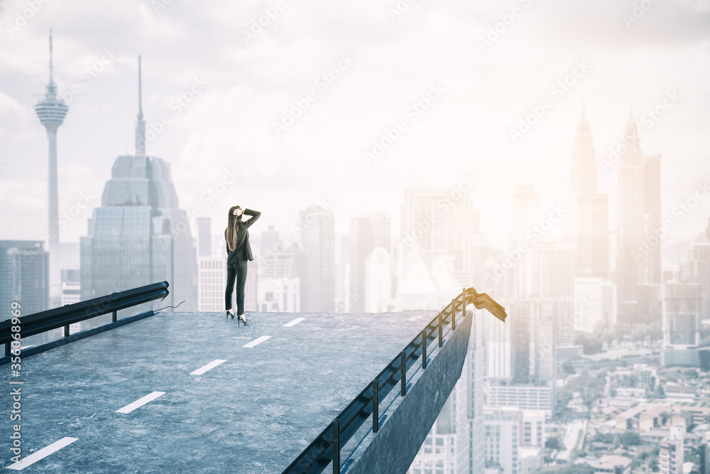 Businesswoman standing on destroyed bridge