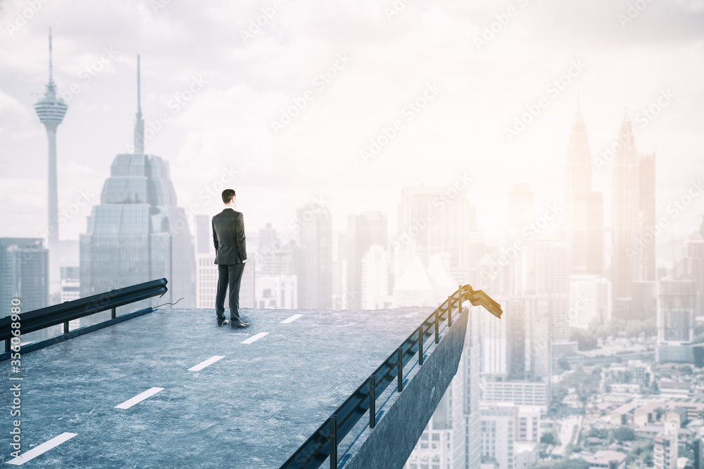 Businessman standing on destroyed bridge