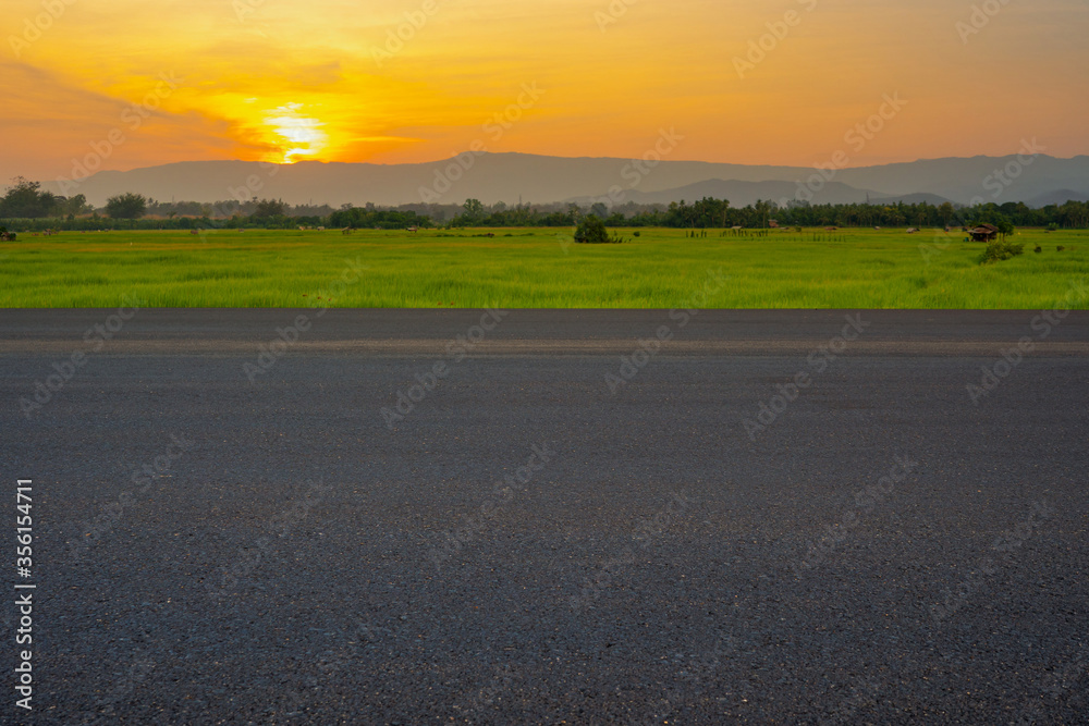 empty asphalt road and sky sunset with clouds in the evening