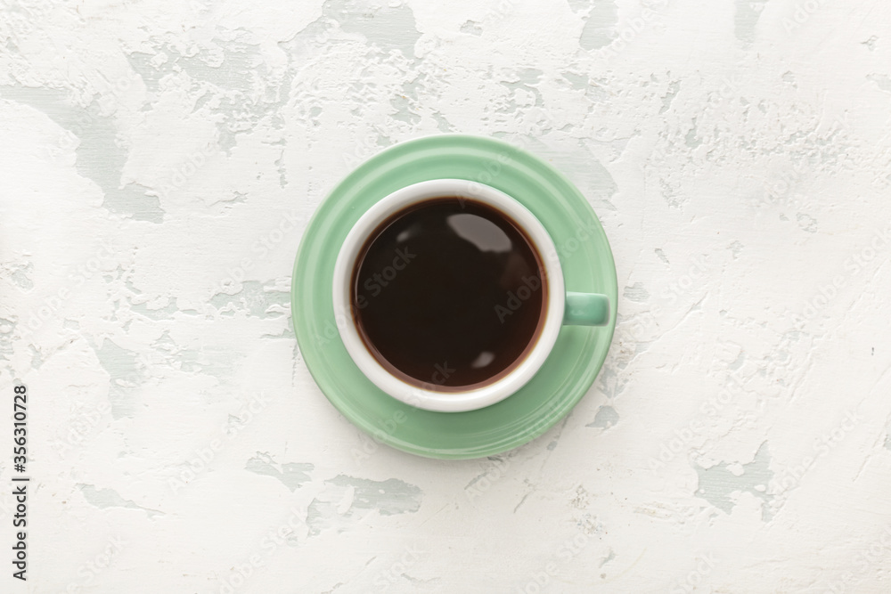 Cup of hot coffee on white background, top view