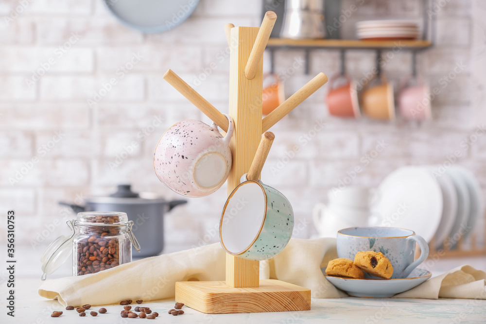 Holder with cups on kitchen table