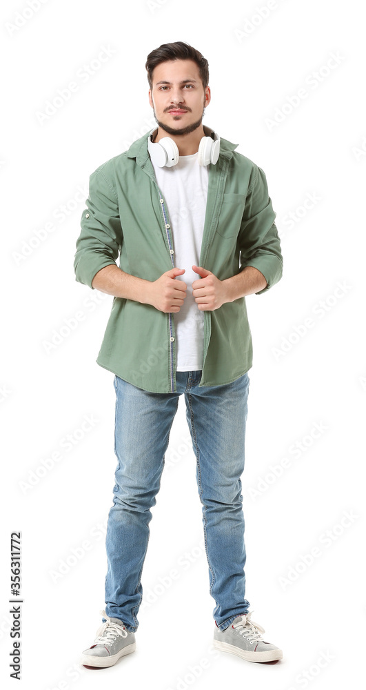 Handsome young man with headphones on white background