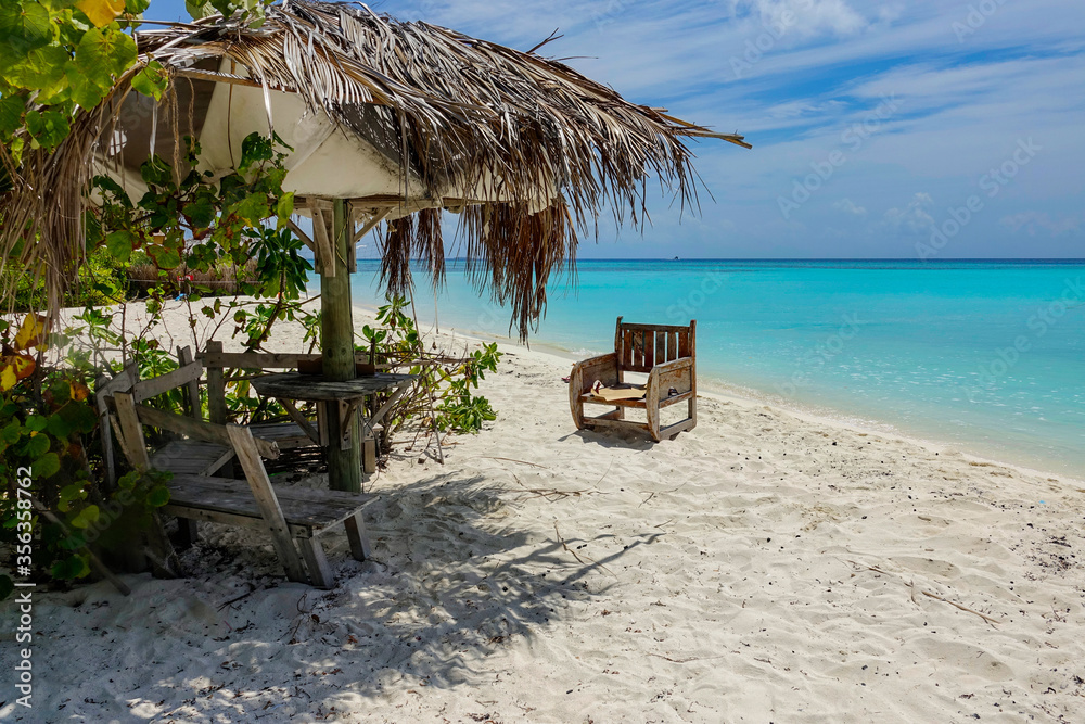 CLOSE UP: Picturesque view of an empty white sand beach in the sunny Maldives.