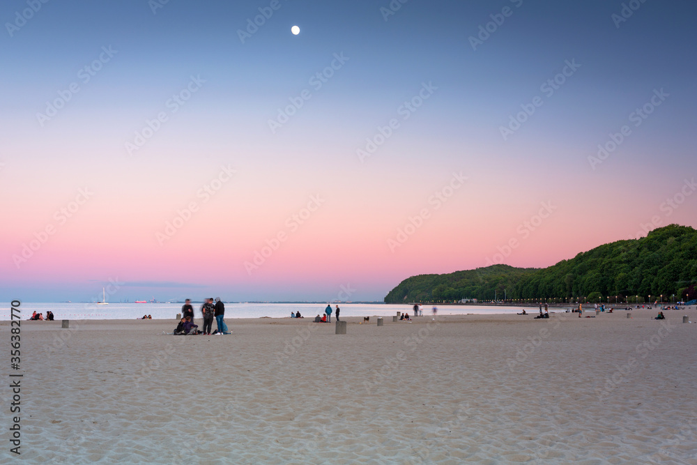 Beautiful sunset over the beach at Baltic Sea in Gdynia, Poland.