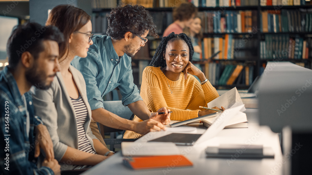 University Library: Diverse Group of Gifted Students Have Discussion, use Laptop, Prepare for Exams 