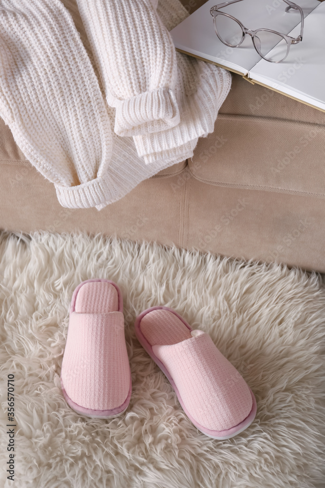 Pair of soft slippers on floor