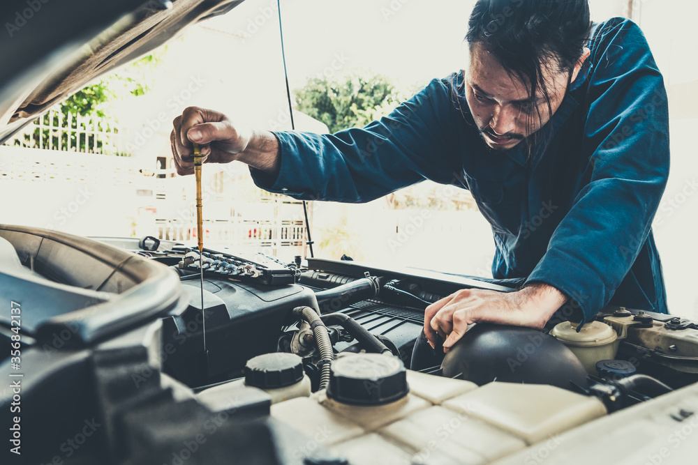 Professional mechanic providing car repair and maintenance service in auto garage. Car service busin