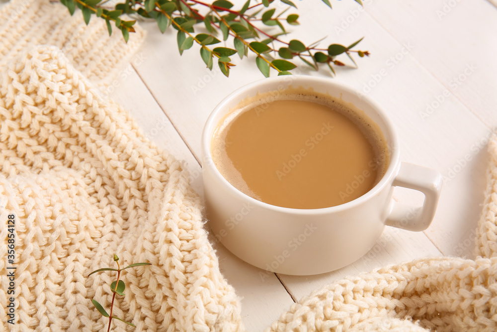 Cup of coffee on white wooden table