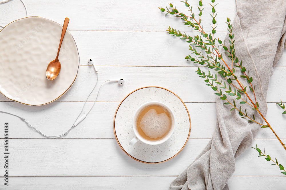 Cup of coffee on white wooden background