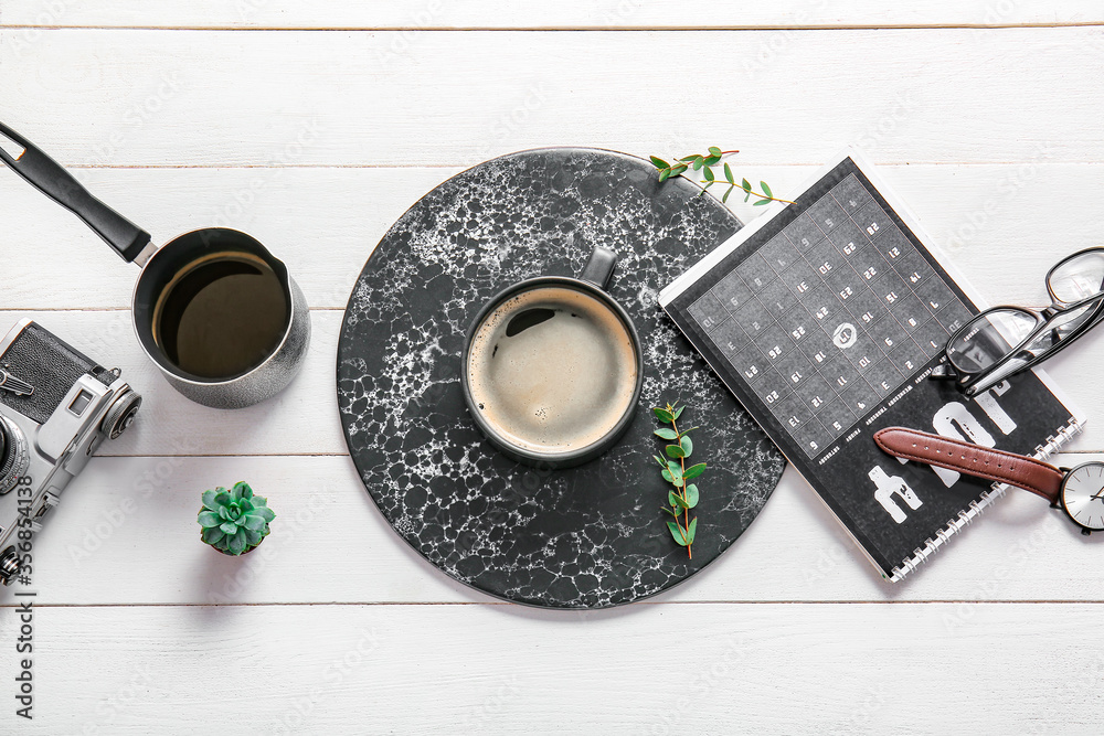 Flat lay composition with cup of coffee on white wooden background