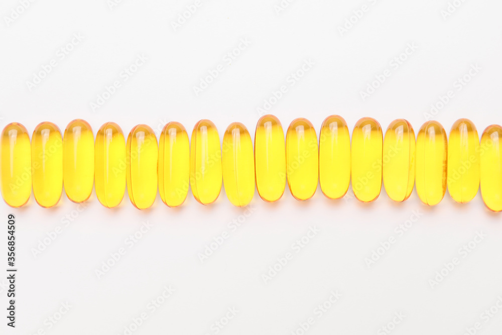 Fish oil capsules on white background