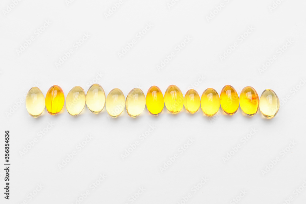 Fish oil capsules on white background