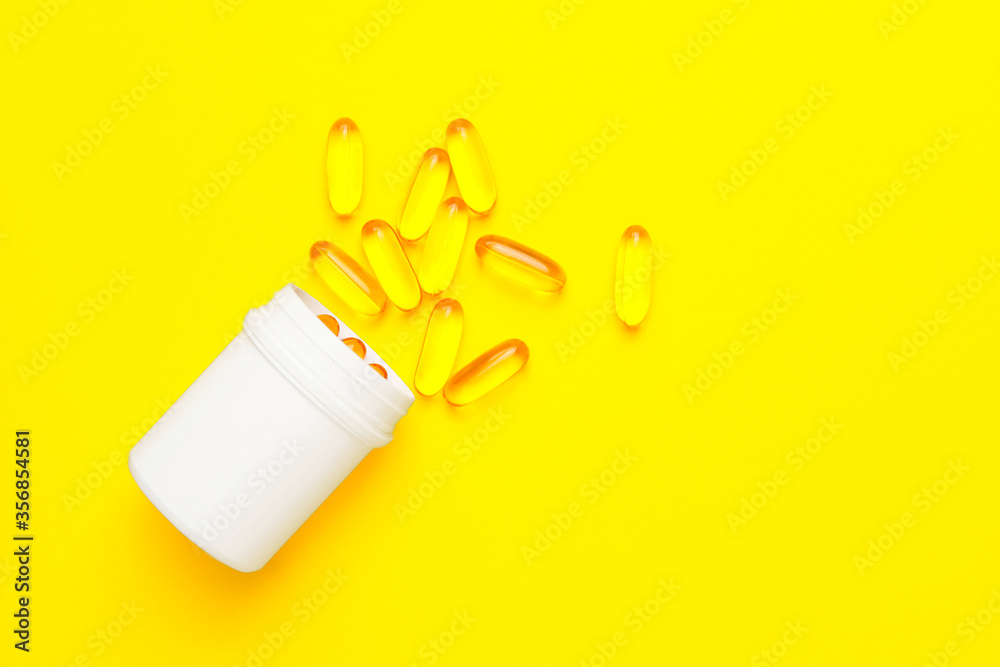 Bottle with fish oil capsules on color background