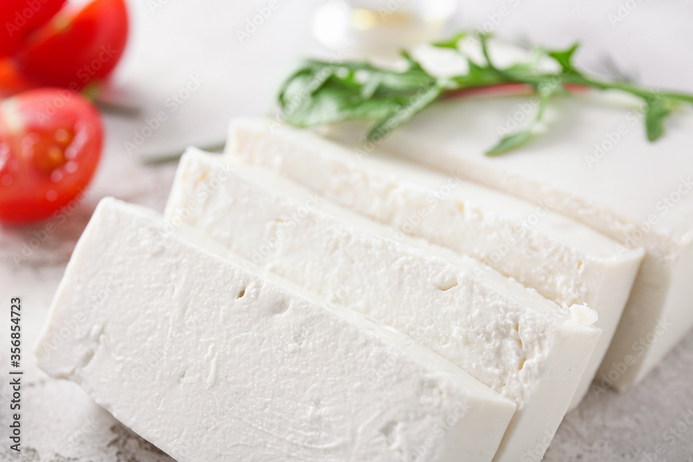 Tasty feta cheese on table, closeup