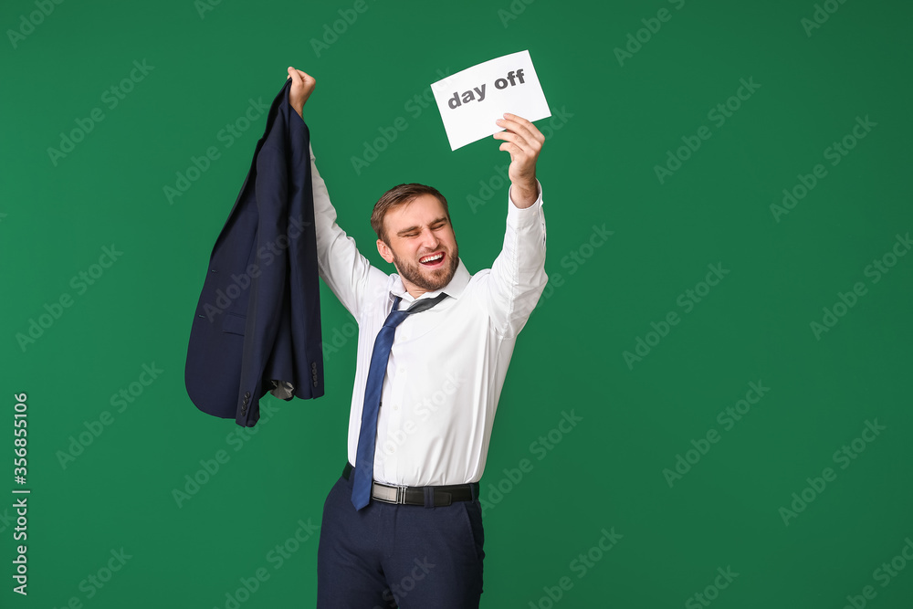 Happy businessman holding paper with text DAY OFF against color background