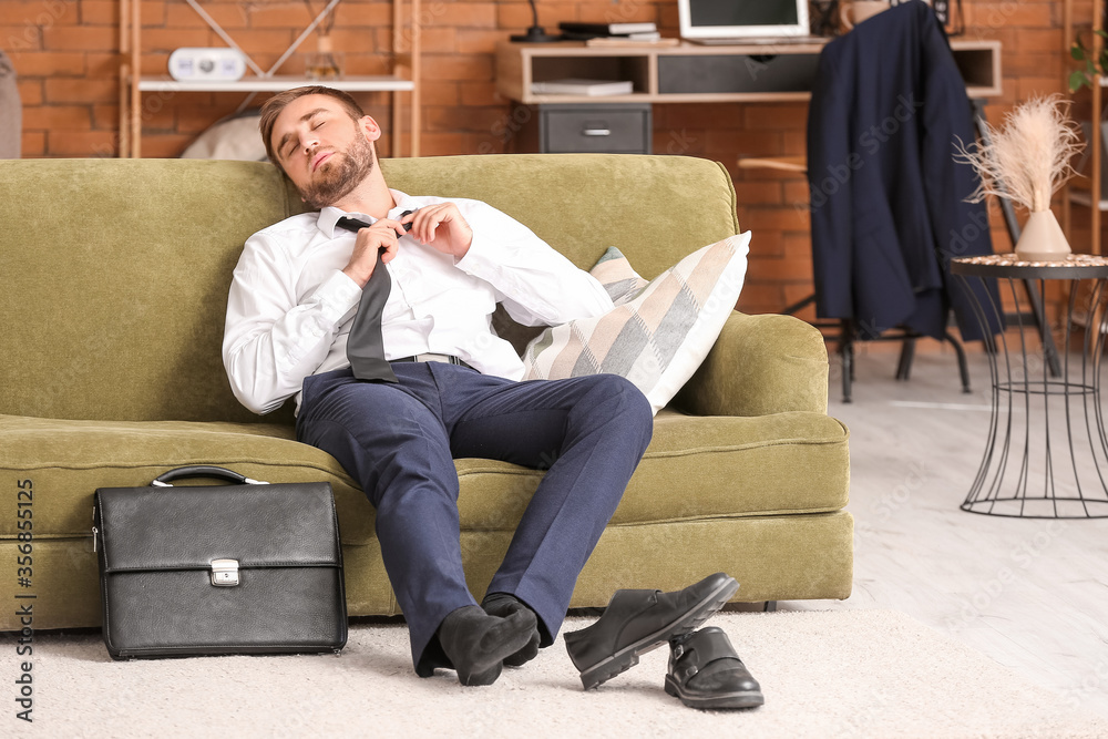 Young businessman resting at home after long working day