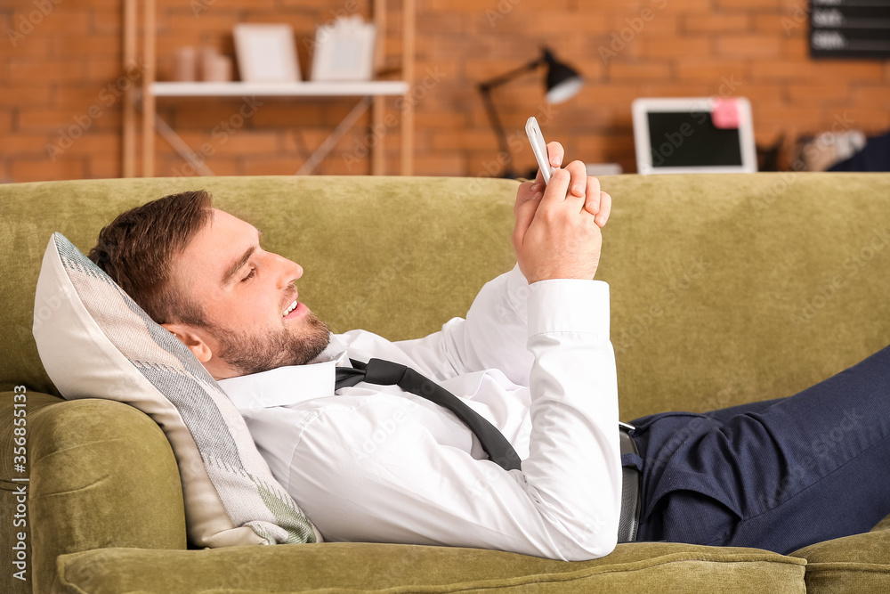 Young businessman resting at home after long working day