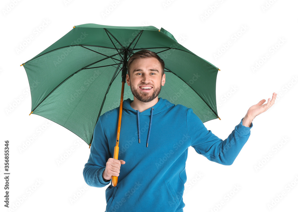 Handsome young man with umbrella on white background