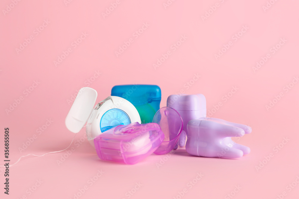 Dental floss on color background