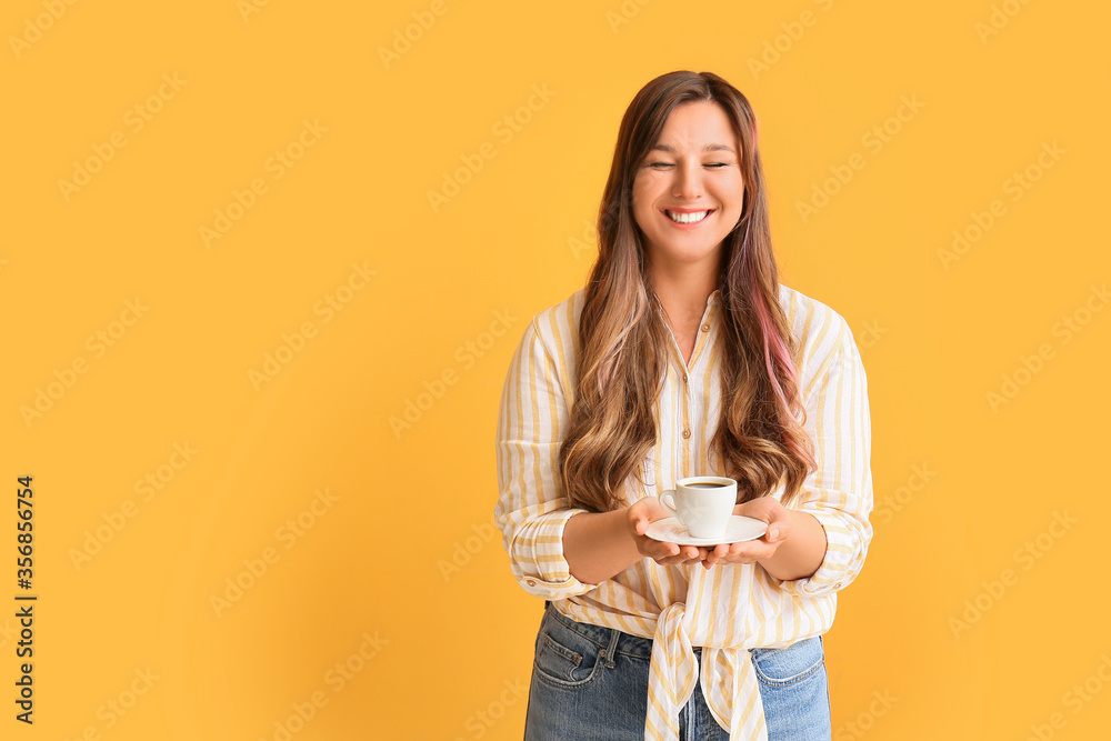 Happy woman drinking hot coffee on color background