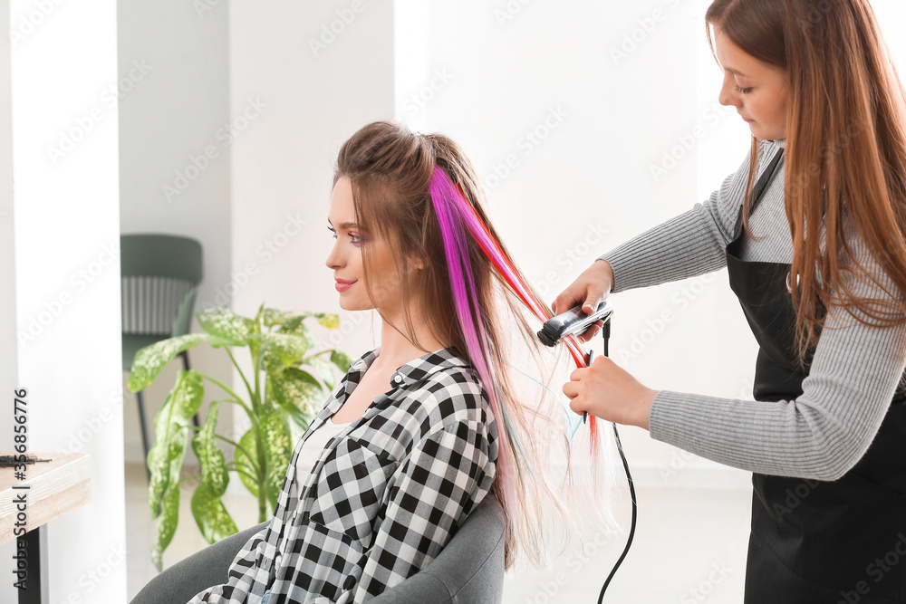 Hairdresser working with young woman in beauty salon