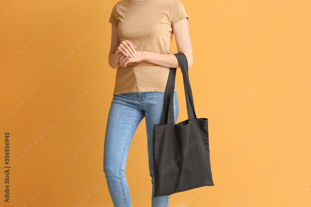 Young woman with eco bag on color background