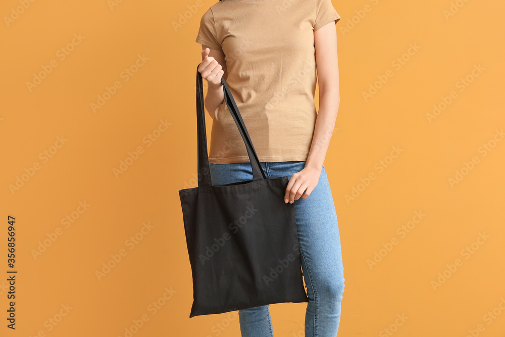 Young woman with eco bag on color background