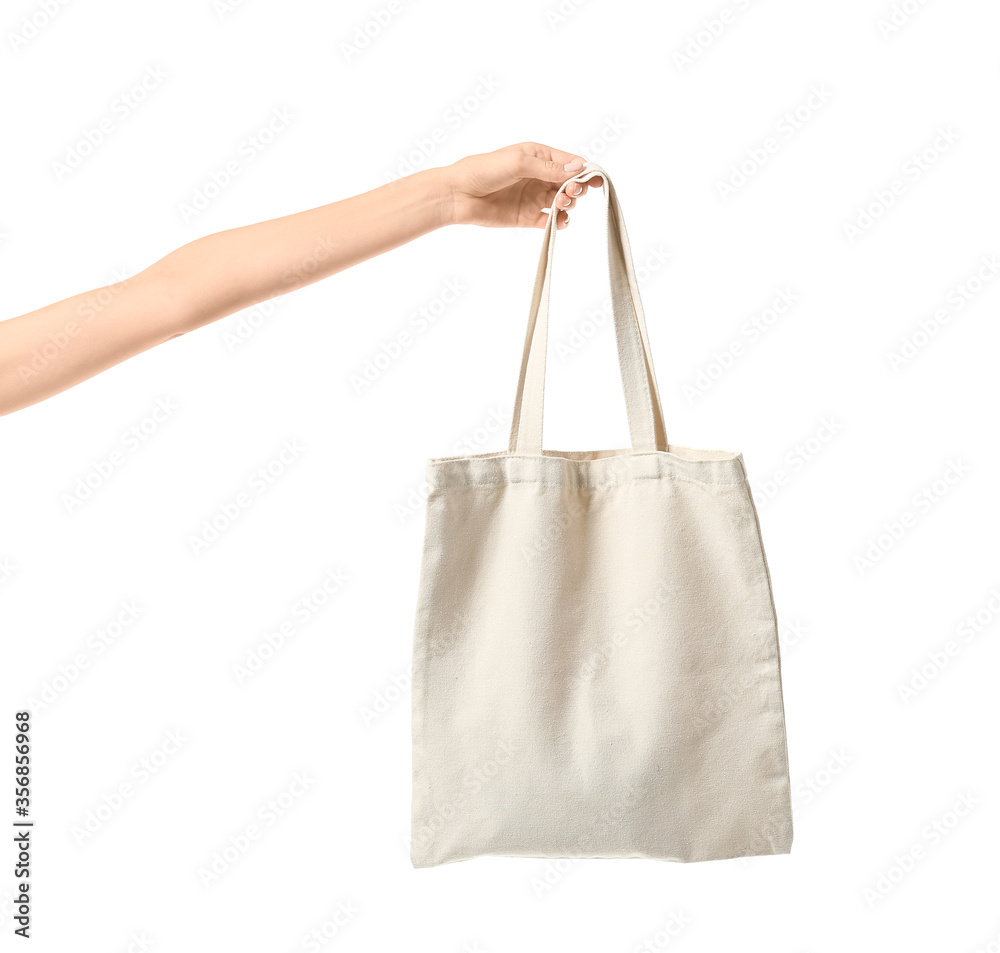 Female hand with eco bag on white background