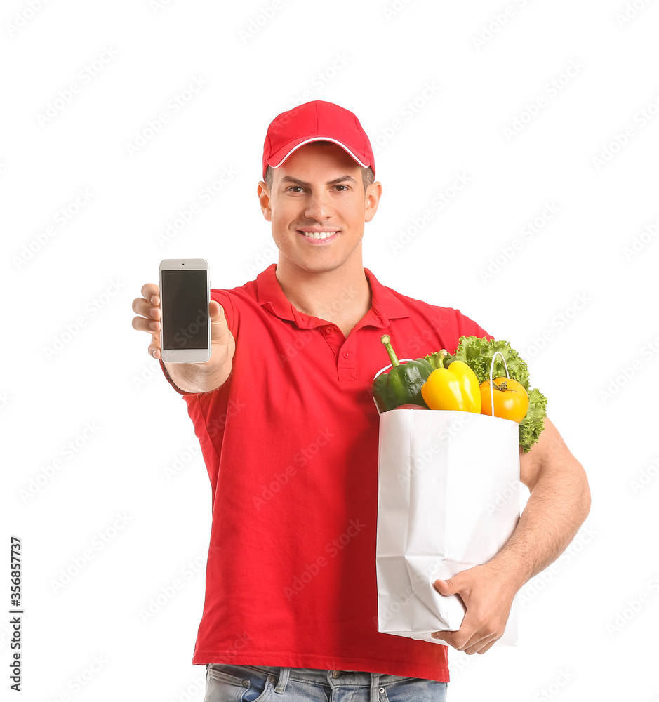 Delivery man with food in bag and mobile phone on white background