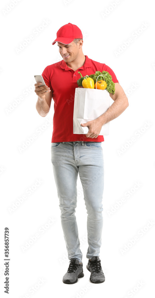 Delivery man with food in bag and mobile phone on white background