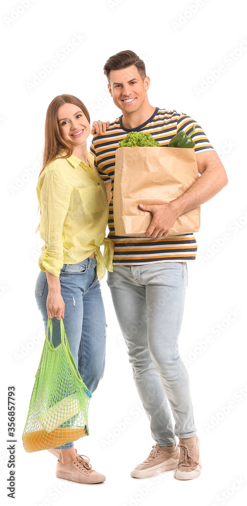 Couple with food in bags on white background