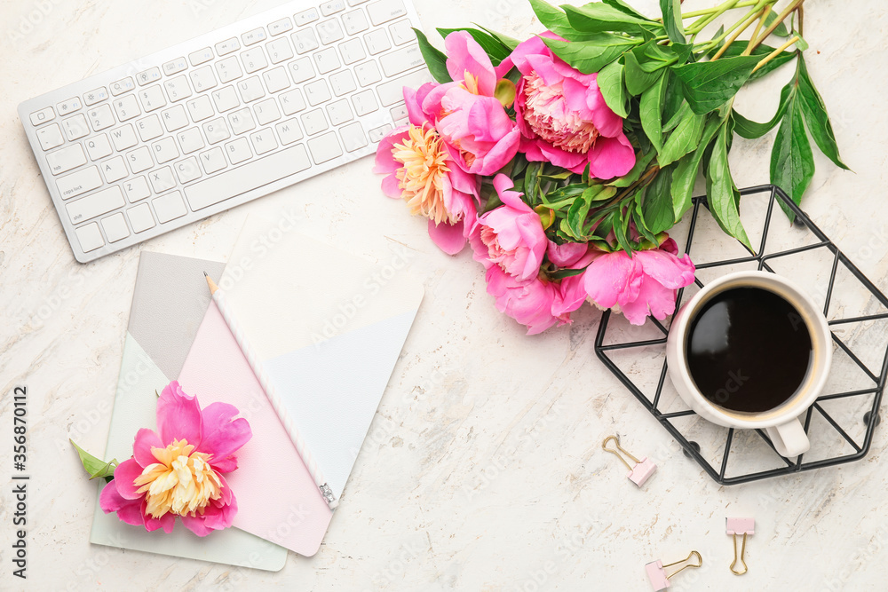 Beautiful peony flowers, cup of coffee and PC keyboard on light background