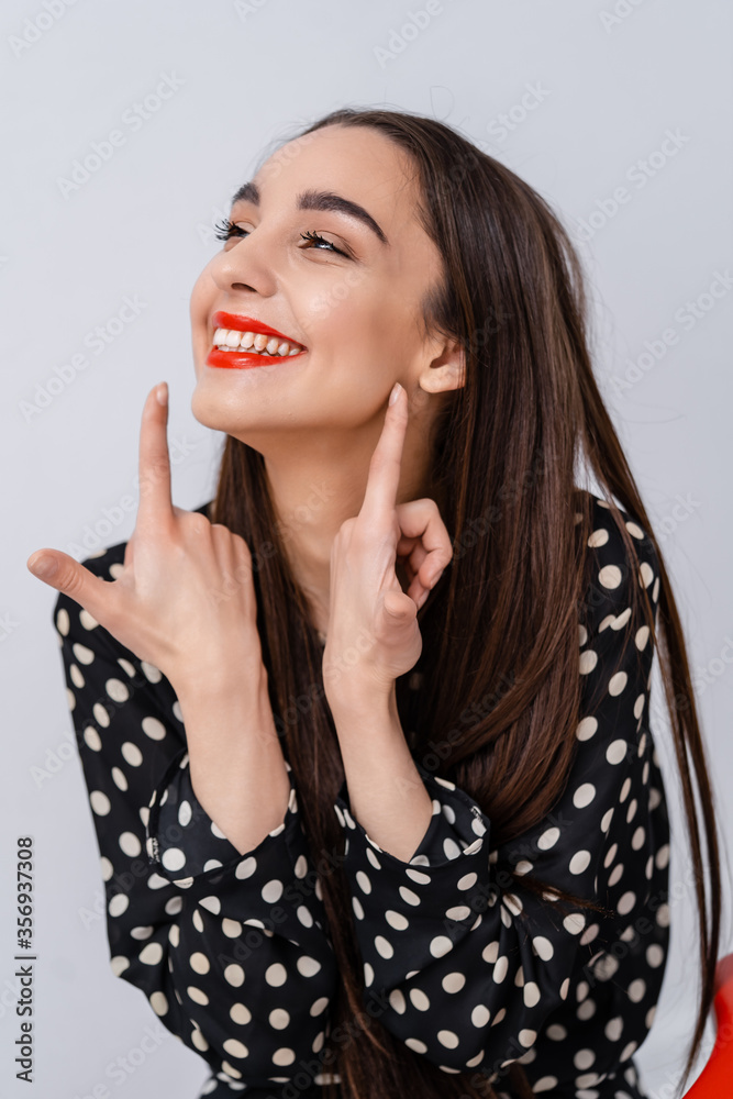 Woman`s portrait. Natural beauty. People emotions. Look to the side, fingers near red lips.