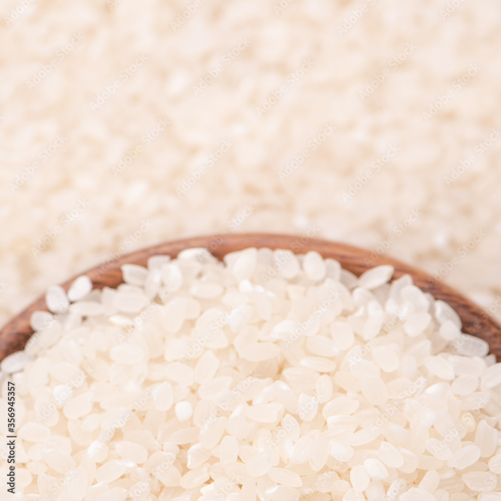 Raw rice in a bowl and full frame in the white background table, top view overhead shot, close up