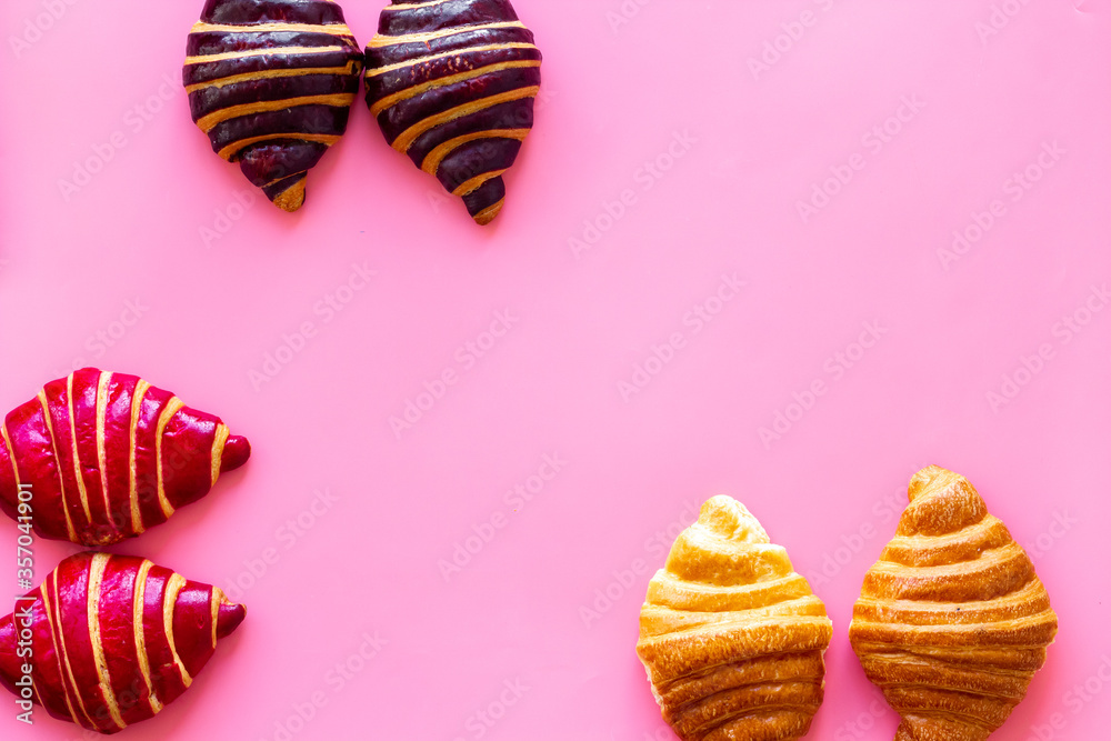 Frame of croissants - fresh bakery on pink background. Top view