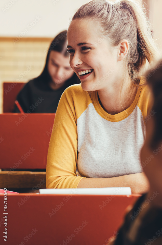 Smiling girl sitting in classroom