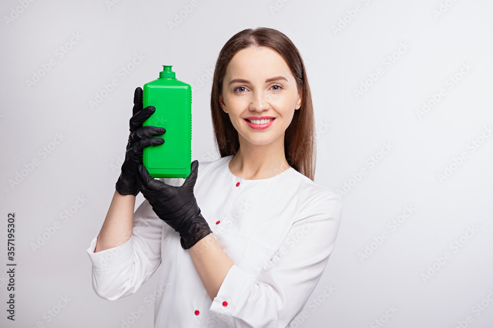 girl with smile holds green jar in her hands, in black gloves holds an antiseptic, joyful emotions o