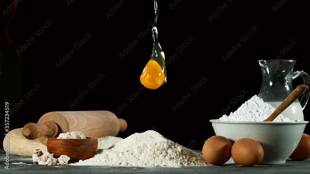 Freeze motion of falling raw egg into flour