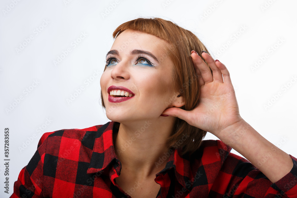 Portrait with different happy emotions. Lady holds hand near ear. Listen carefully.