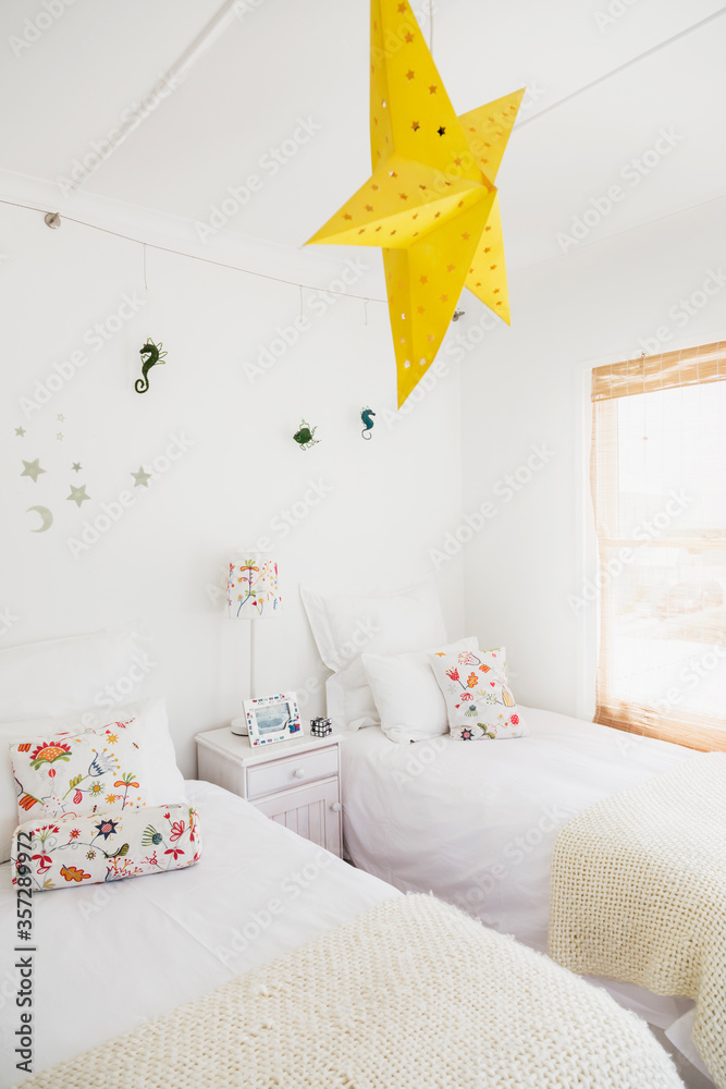 Yellow star lamp and wall decorations in children bedroom