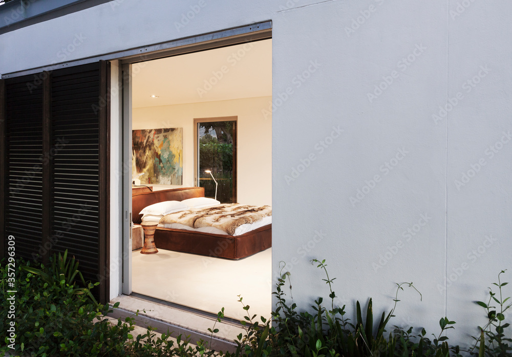 Sliding door open to modern bedroom