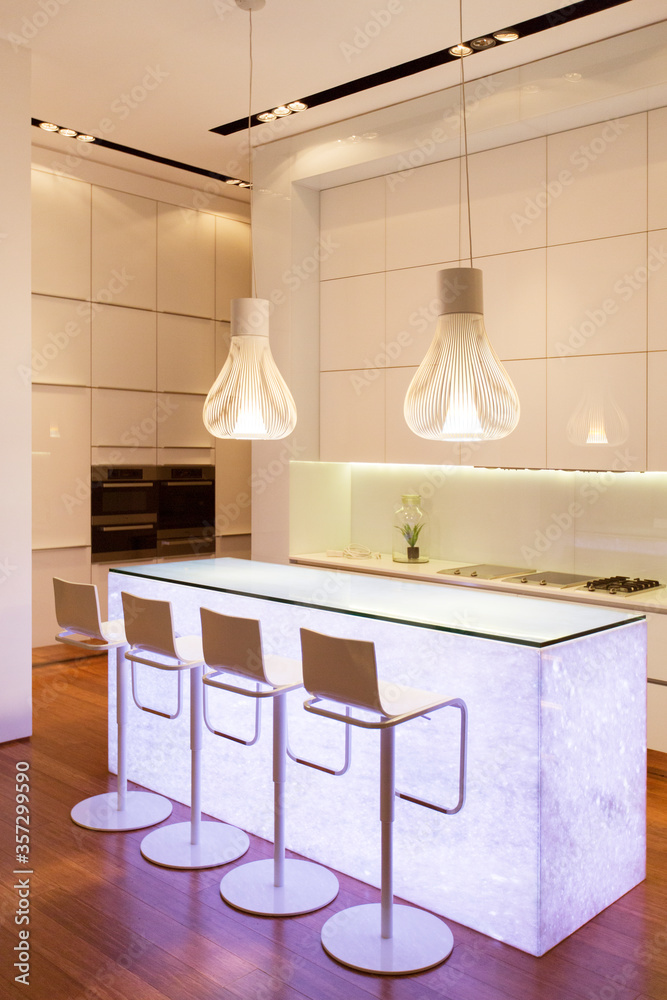 Bar stools and light features in modern kitchen