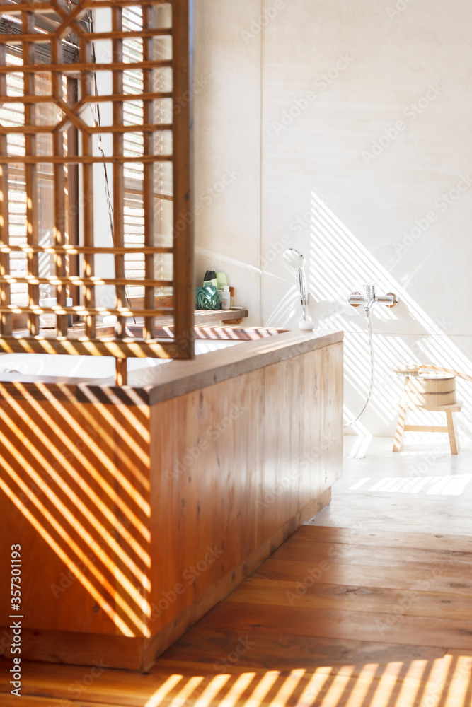 Blinds casting shadows in modern bathroom