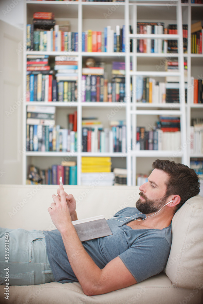 Man listening to music on sofa