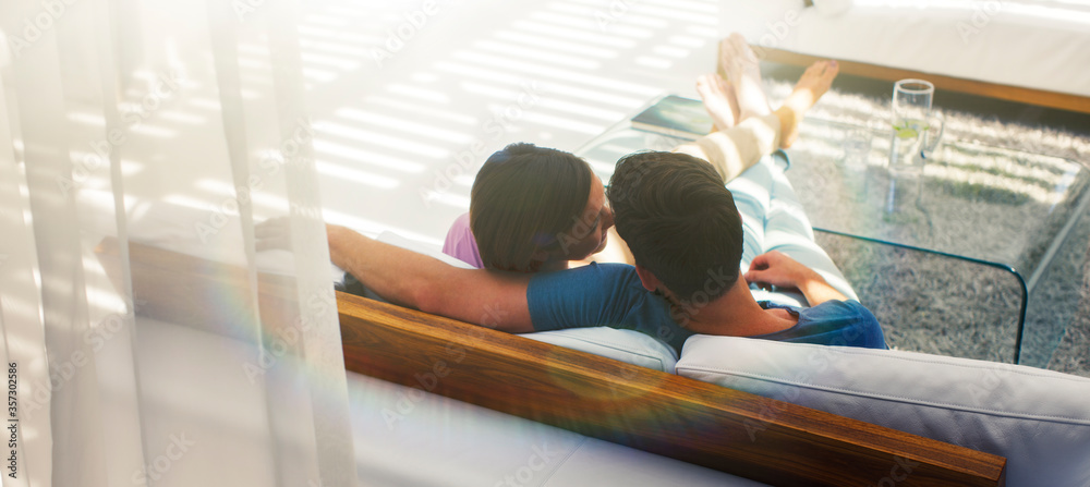 Couple relaxing together on sofa in modern living room