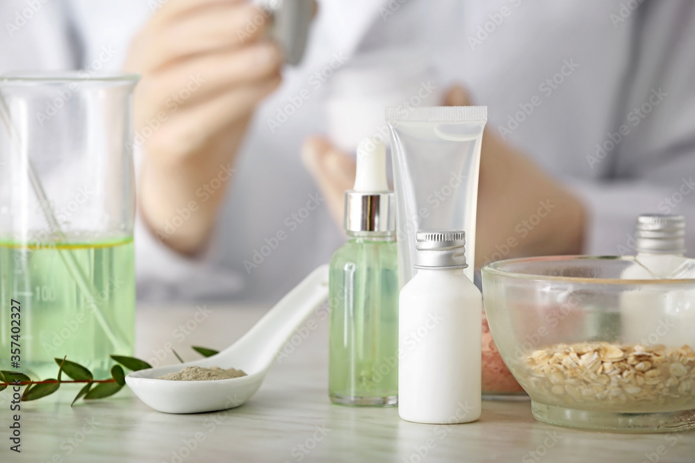 Natural cosmetics with ingredients on table in laboratory