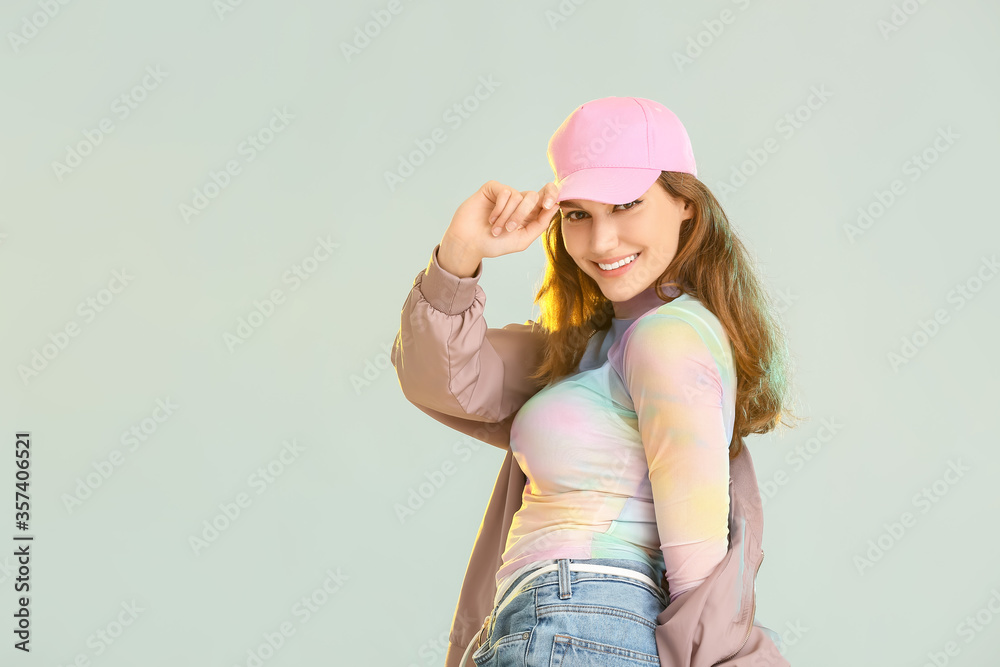 Beautiful female hip-hop dancer on grey background