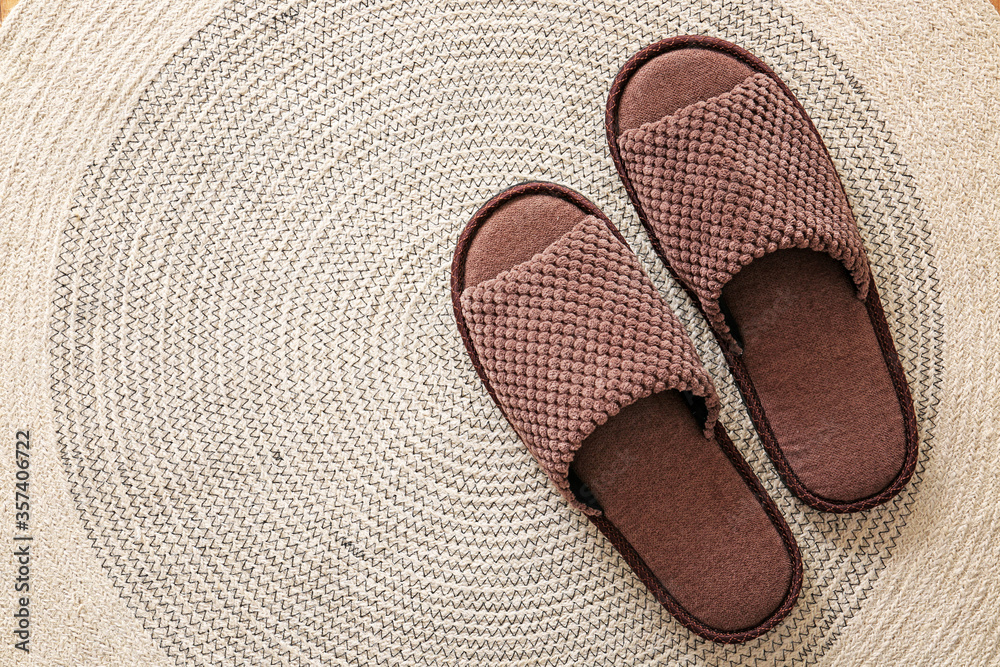 Pair of soft slippers on rug