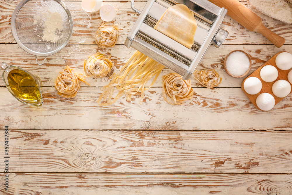 Pasta machine with ingredients on table