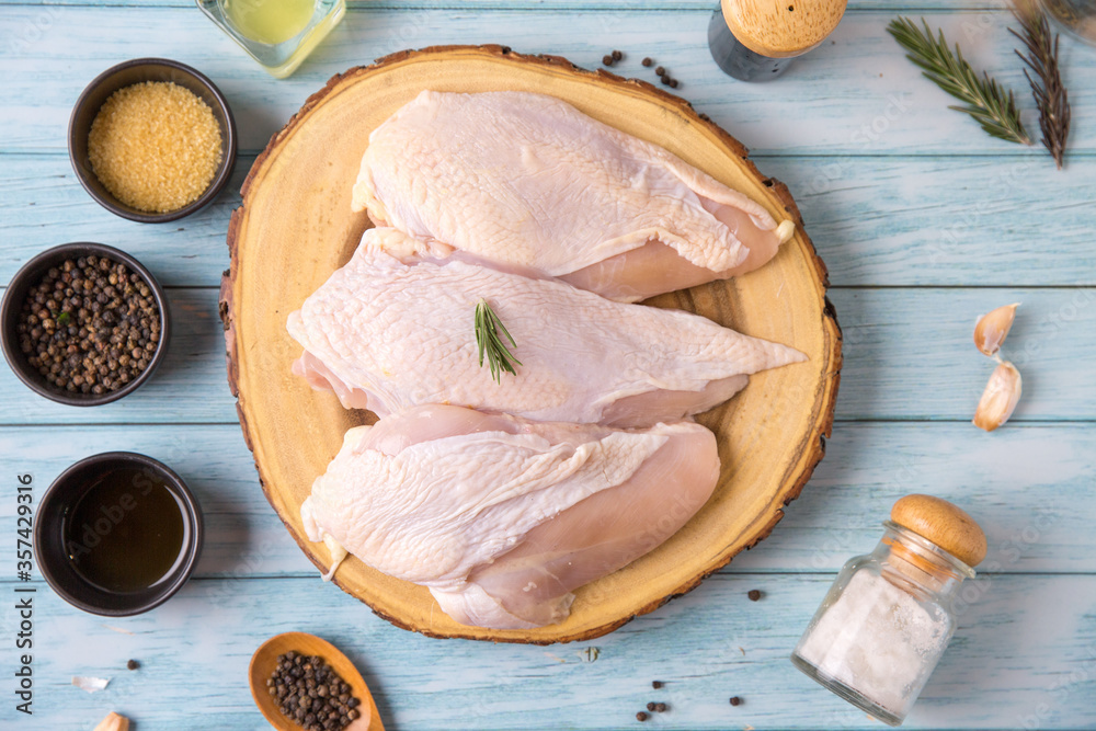 Raw chicken, on a wooden board, meat containing ingredients for cooking